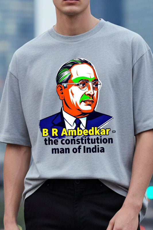 close up view of a man wearing a gray melange oversized t-shirt with a graphic of B R Ambedkar and text.