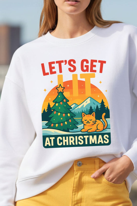 close up of a white oversized sweatshirt with Christmas-themed design featuring a cat and tree, worn by a woman.