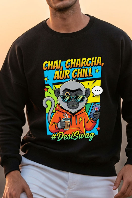 close up view of a black oversized sweatshirt with a colorful graphic of a monkey holding a phone and cup, with text 'Chai, Charcha, Aur Chill' and '#DesiSwag'.