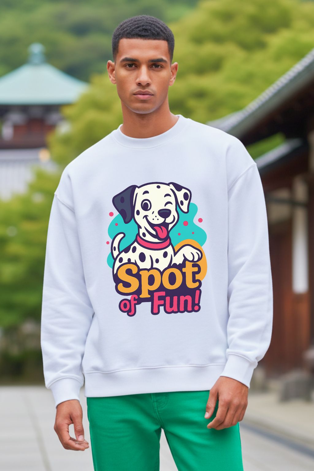 Man wearing a white oversized sweatshirt with a colorful dog graphic and 'Spot of Fun!' text, standing outdoors.