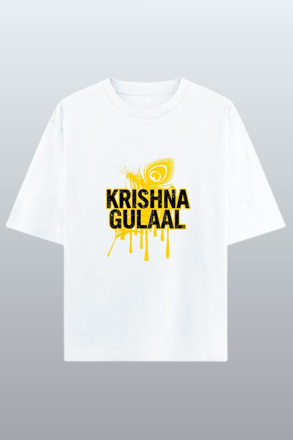 flat lay view of a white oversized t-shirt with yellow and black text "Krishna Gulaal" and design on a gray background
