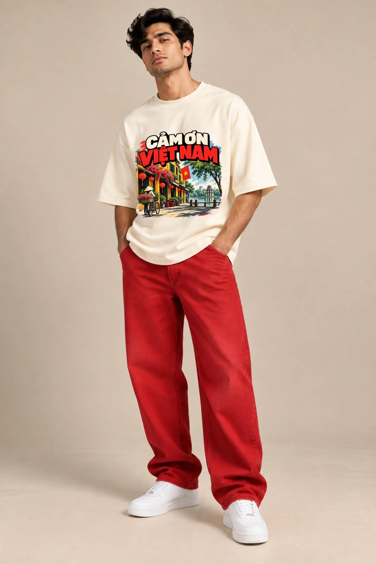 Man wearing Cam On Vietnam — Gratitude Travel Oversized Terry T-Shirt in off-white with red baggy jeans | JUNOSHI