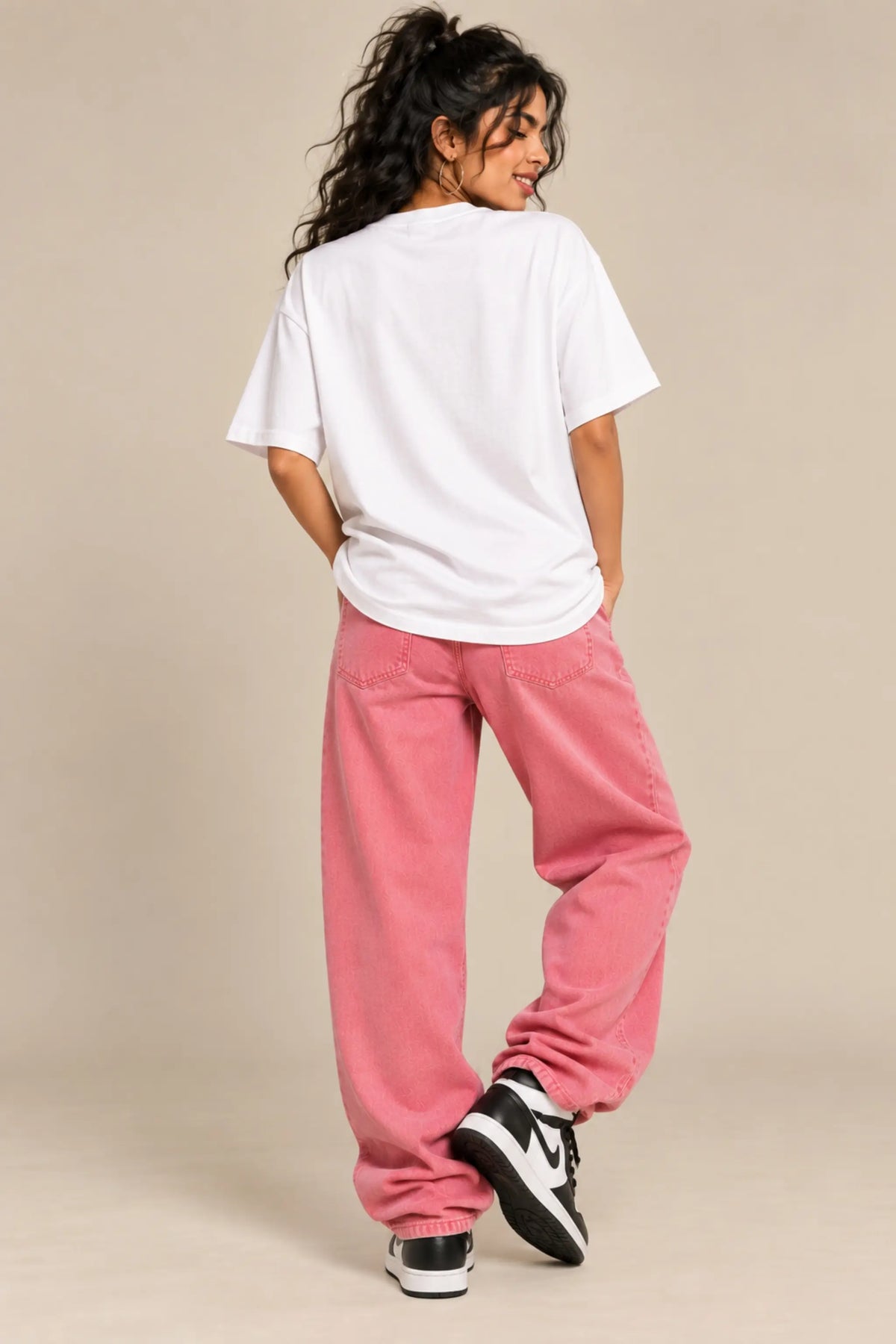 Back view of white oversized terry t-shirt worn with pink baggy jeans and sneakers, Desi Girl Anime Soul collection, JUNOSHI
