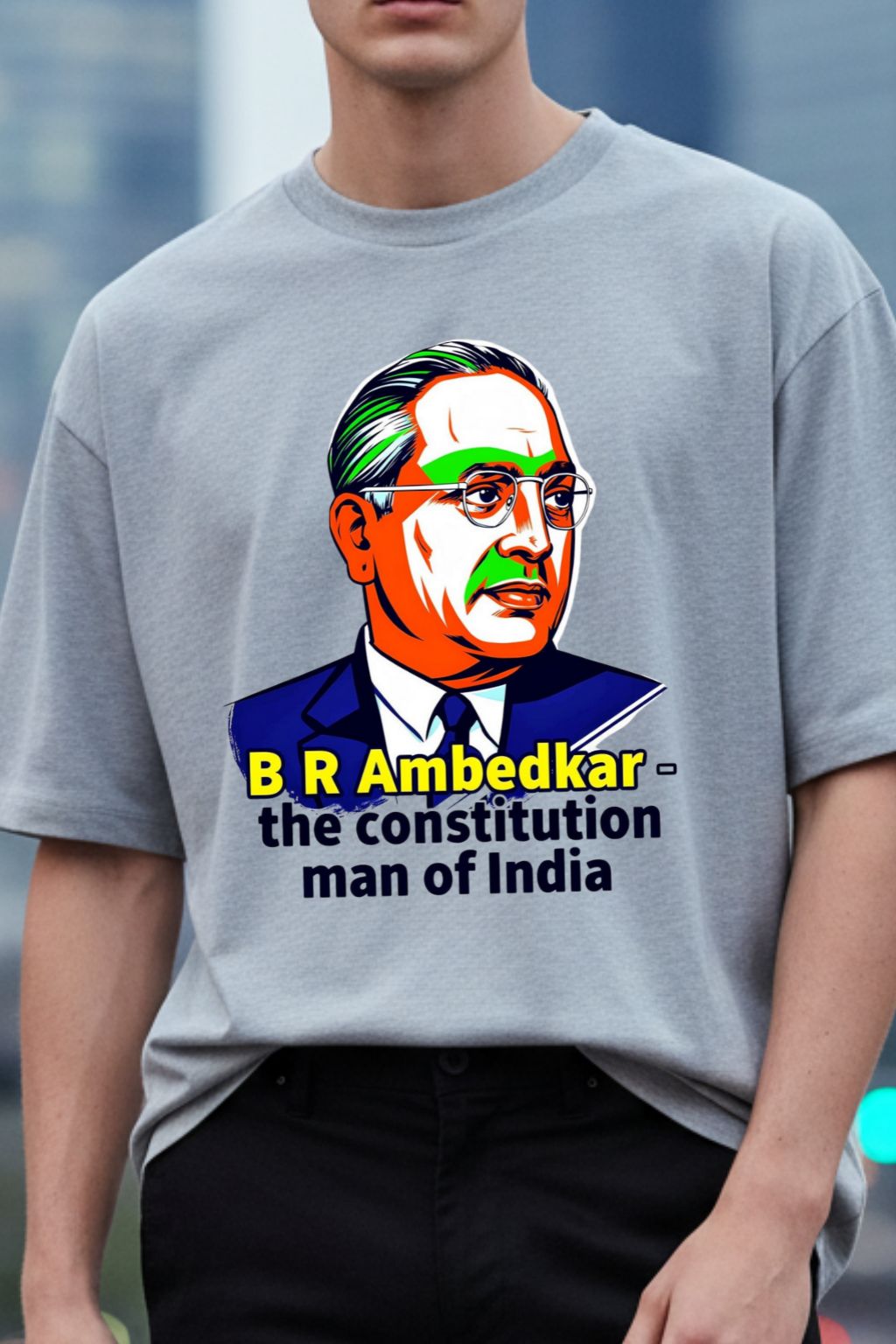close up view of a man wearing a gray melange oversized t-shirt with a graphic of B R Ambedkar and text.