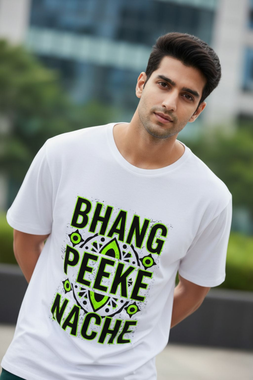 side view of a man wearing a white oversized t-shirt with green text "bhang peeke nache" outdoors