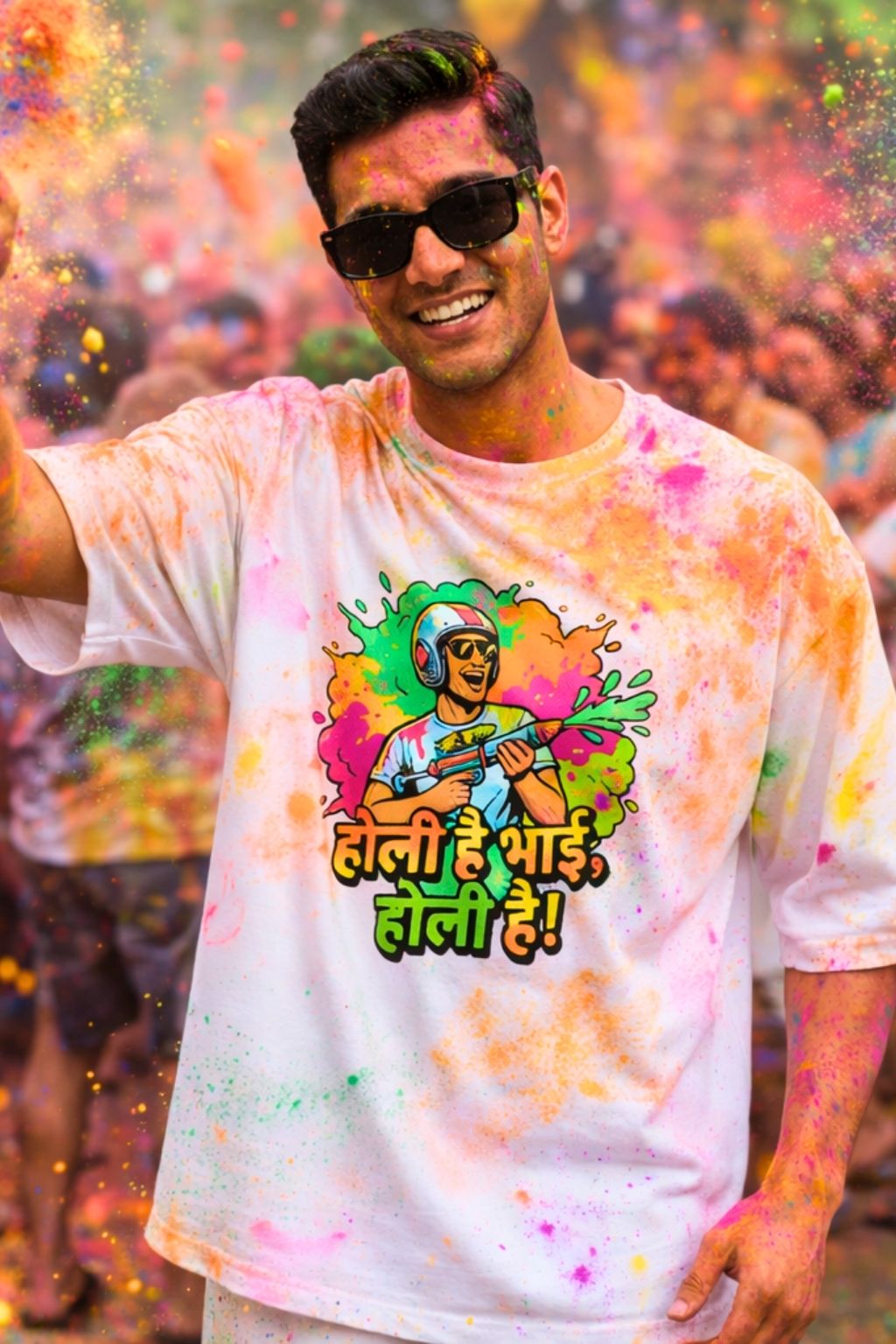 man with colorful oversized white t-shirt with text " Holi hai bhai, holi hai" and sunglasses at a Holi celebration