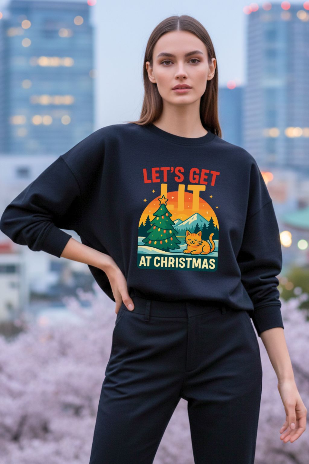 Woman wearing a black oversized sweatshirt with a Christmas-themed design in an urban setting.