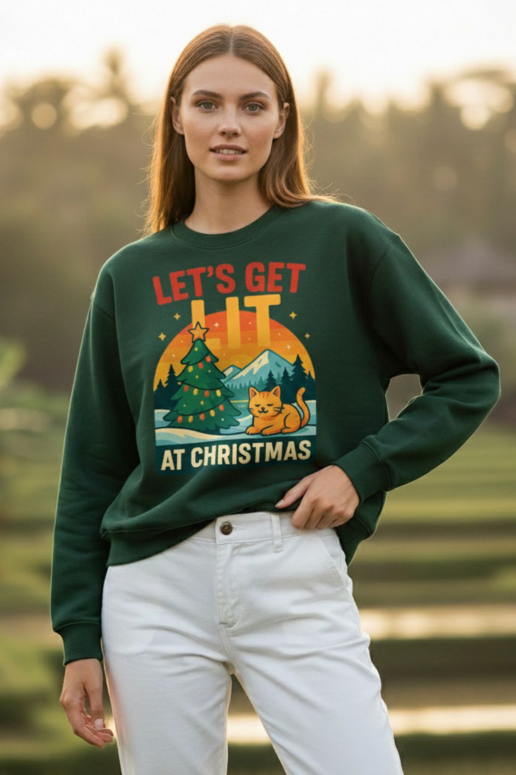 Woman wearing a bottle green oversized sweatshirt with a Christmas-themed design outdoors.