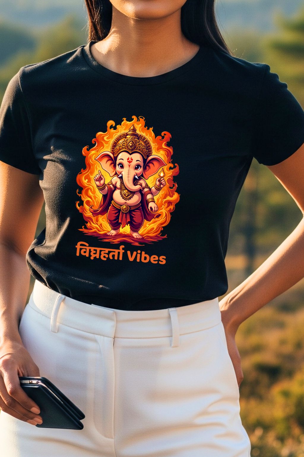 Detailed close-up of the colorful graphic of the Hindu deity Lord Ganesha on a black t-shirt, highlighting the design details.