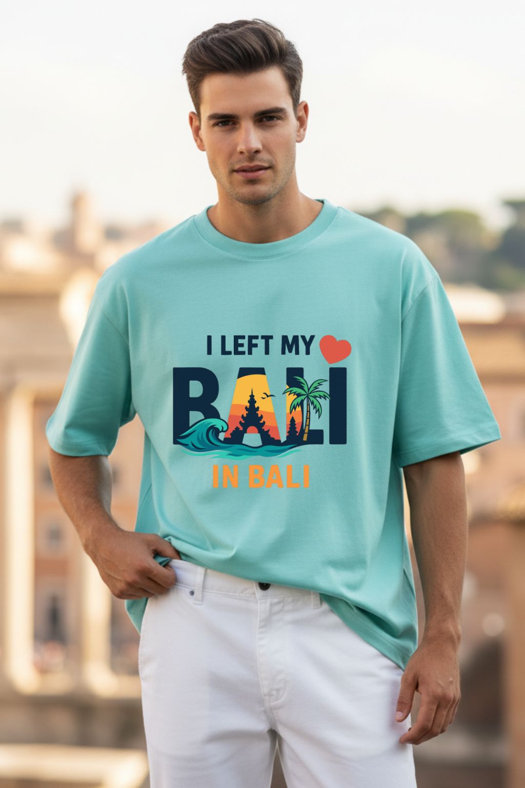 Man wearing mint oversized t-shirt with I Left My Heart In Bali graphic print — JUNOSHI men's Bali travel tee, relaxed fit