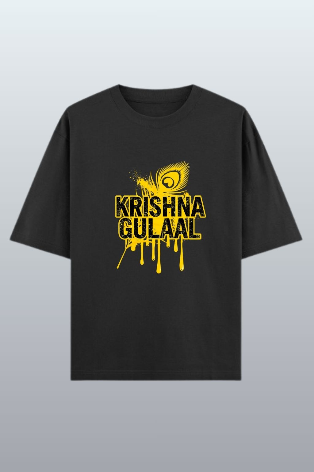 flat lay view of a black oversized t-shirt with yellow 'Krishna Gulaal' graphic on a light gray background