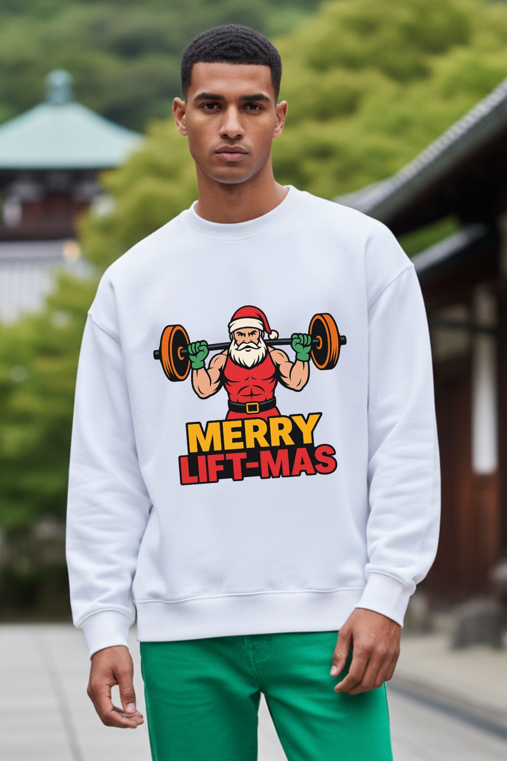 Man wearing a white oversized sweatshirt with a Christmas-themed graphic and text.