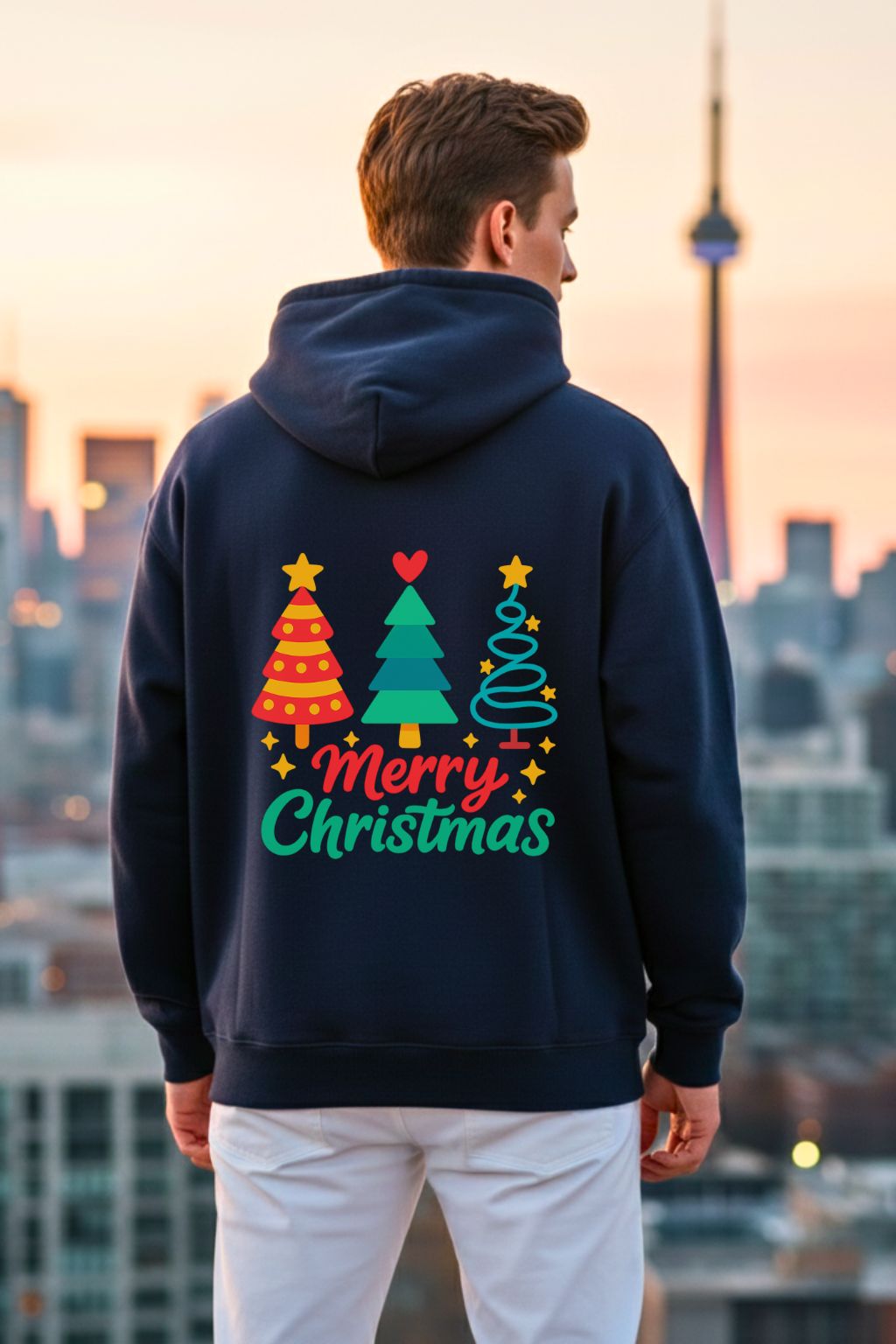 back view of a man wearing a navy blue hoodie with colorful Christmas tree design and 'Merry Christmas' text, standing against a cityscape background.
