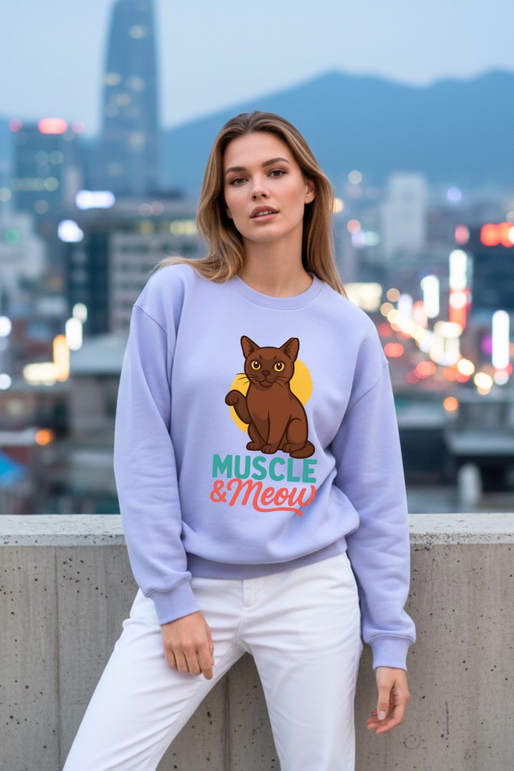 Woman wearing a lavendar oversized  sweatshirt with a cat graphic and text, standing against a cityscape background.