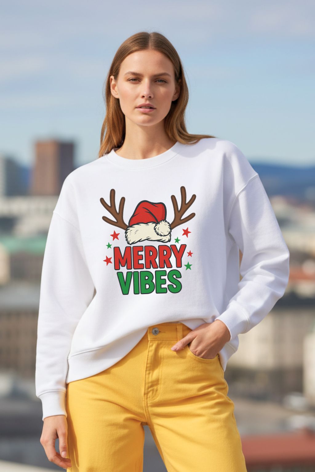 Woman wearing a white oversized sweatshirt with 'Merry Vibes' text and reindeer antlers, standing outdoors.