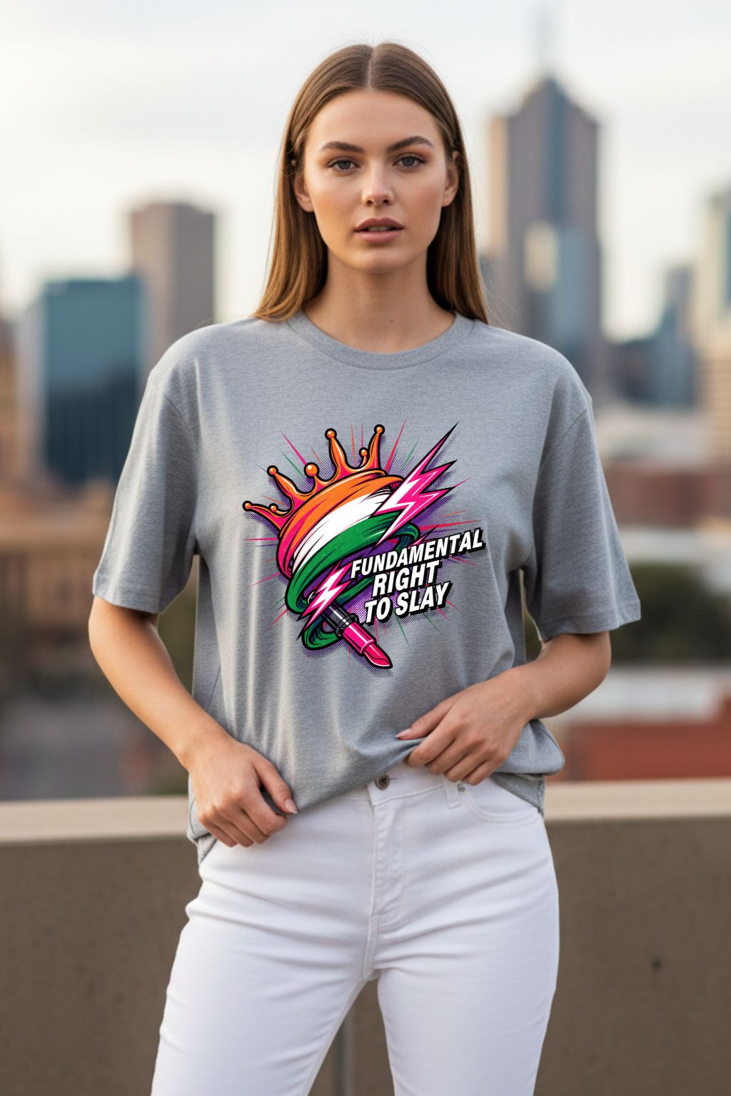 Woman wearing a gray melange oversized  t-shirt with a colorful graphic and text, standing against a cityscape background.