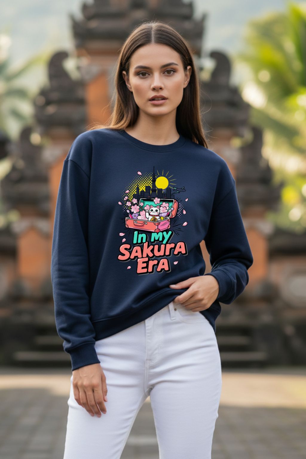 Woman wearing a navy blue oversized sweatshirt with colorful graphic design in an outdoor setting.