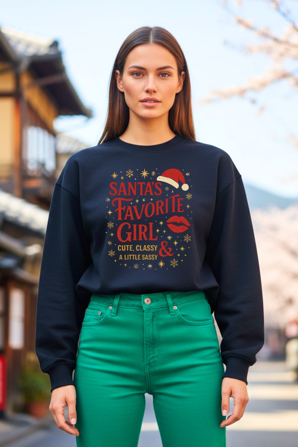 Woman wearing a black oversized sweatshirt with festive text and graphics, standing outdoors.