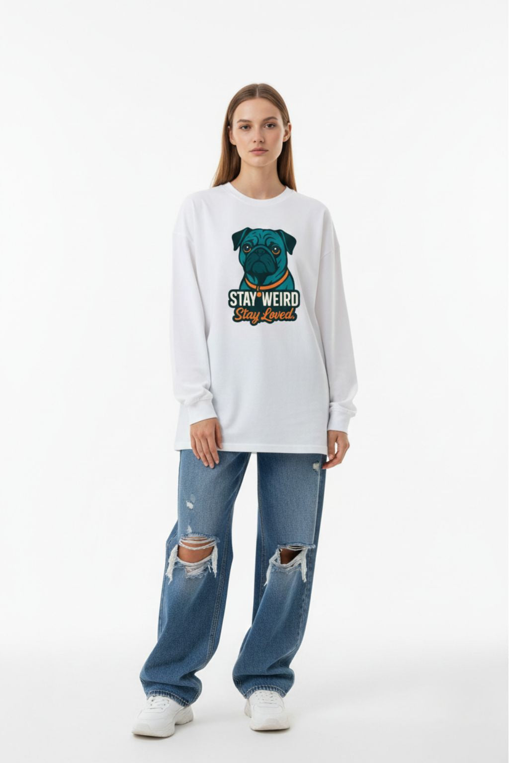 Woman wearing a white oversized sweatshirt with a graphic design and ripped jeans on a white background