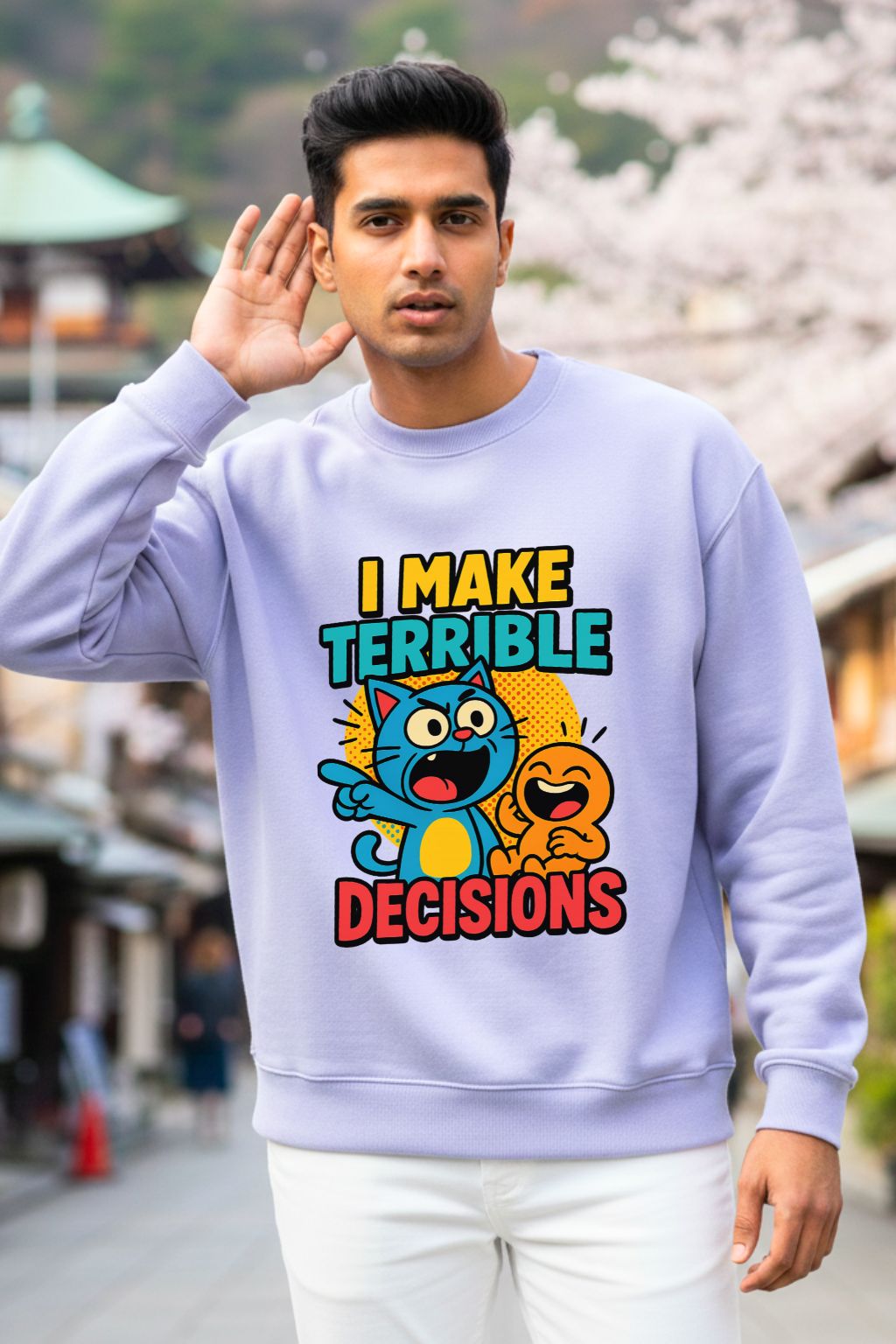 Man wearing a lavendar oversized  sweatshirt with a colorful graphic and text, standing outdoors.