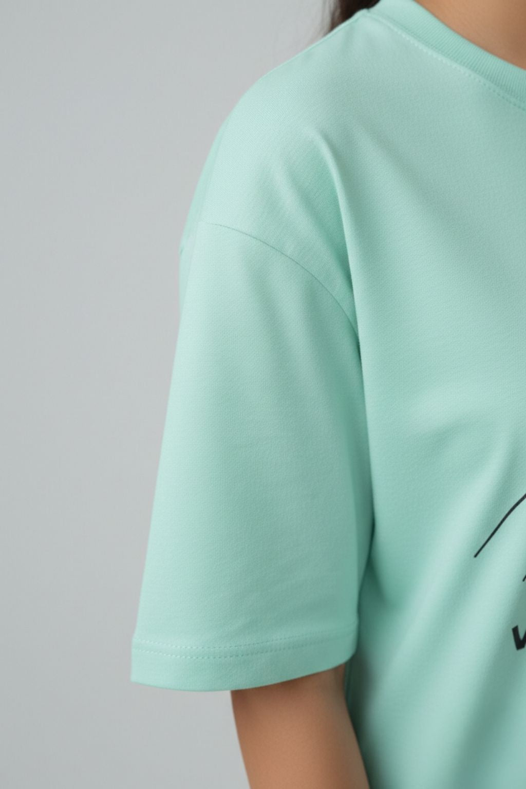 mint oversized t-shirt worn by a woman a plain background with a design of "upsc aspirant zero variables"