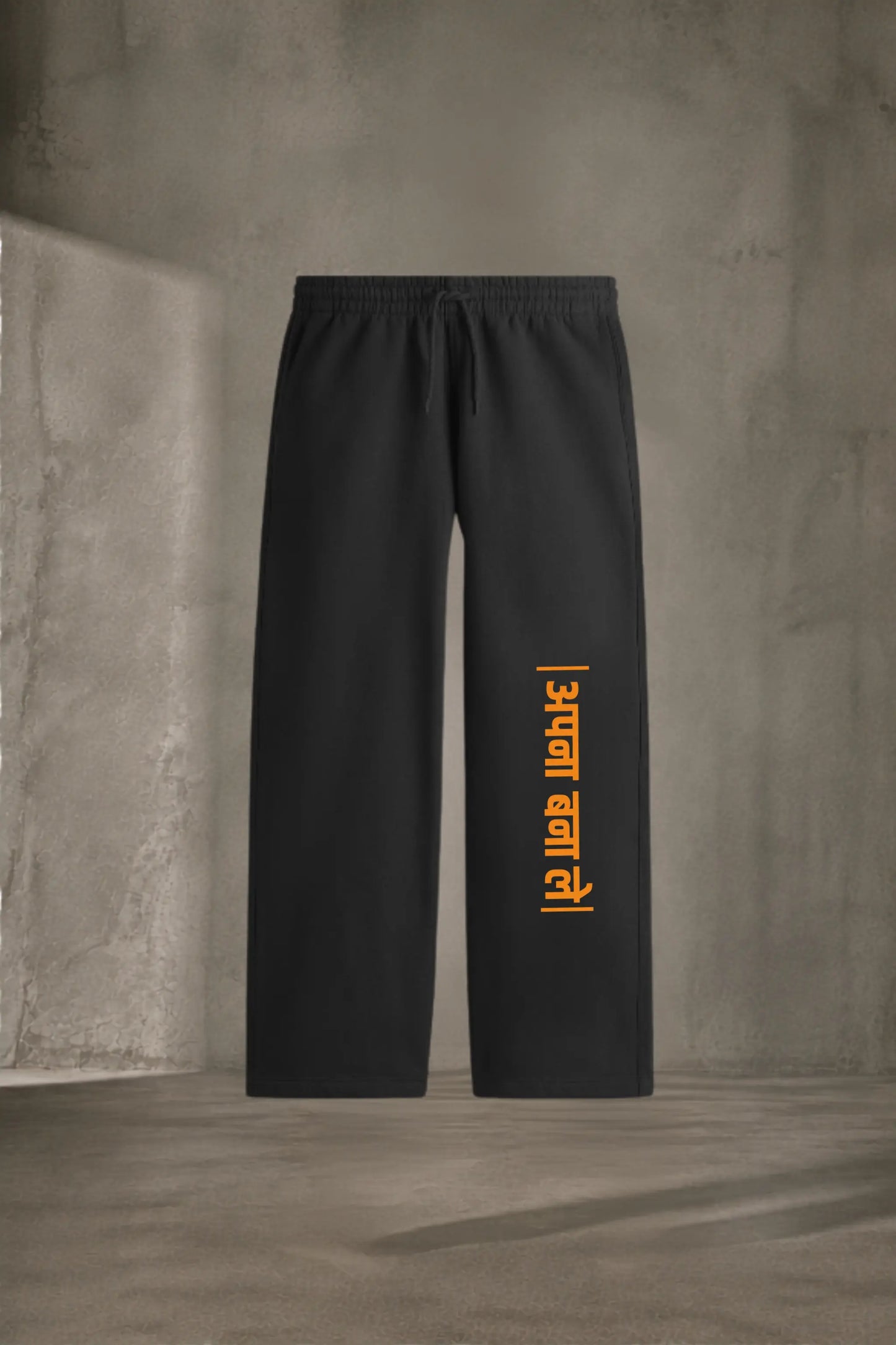 Apna Bana Le Hindi Graphic Sweatpants — Black with Orange Devanagari Print, Product Flat Lay | JUNOSHI