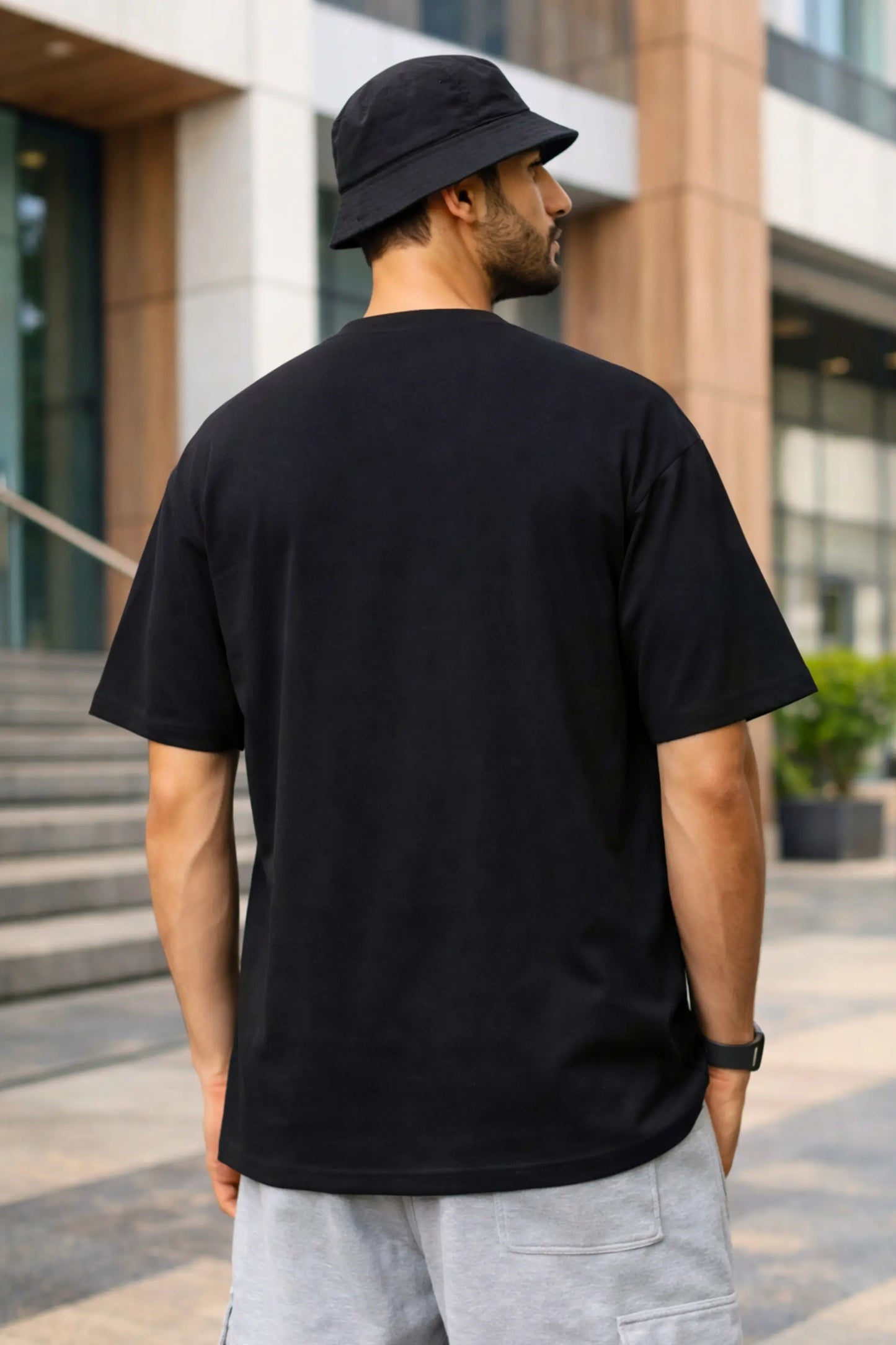 Back view of Arc Start oversized terry T-shirt in black — drop shoulder fit, clean back, premium fabric quality by JUNOSHI