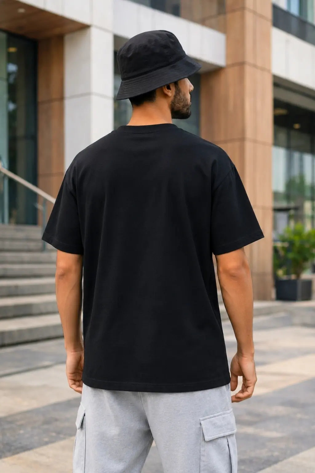 Back view of Azadi Ka Jazba black oversized tee on male model — drop shoulder fit, freedom streetwear India | JUNOSHI