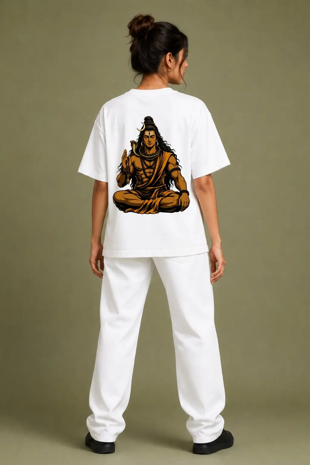Dakshinamurthy Shiva oversized tee back print worn by woman featuring meditating Shiva with cobra and rudraksha — Divine Street stillness