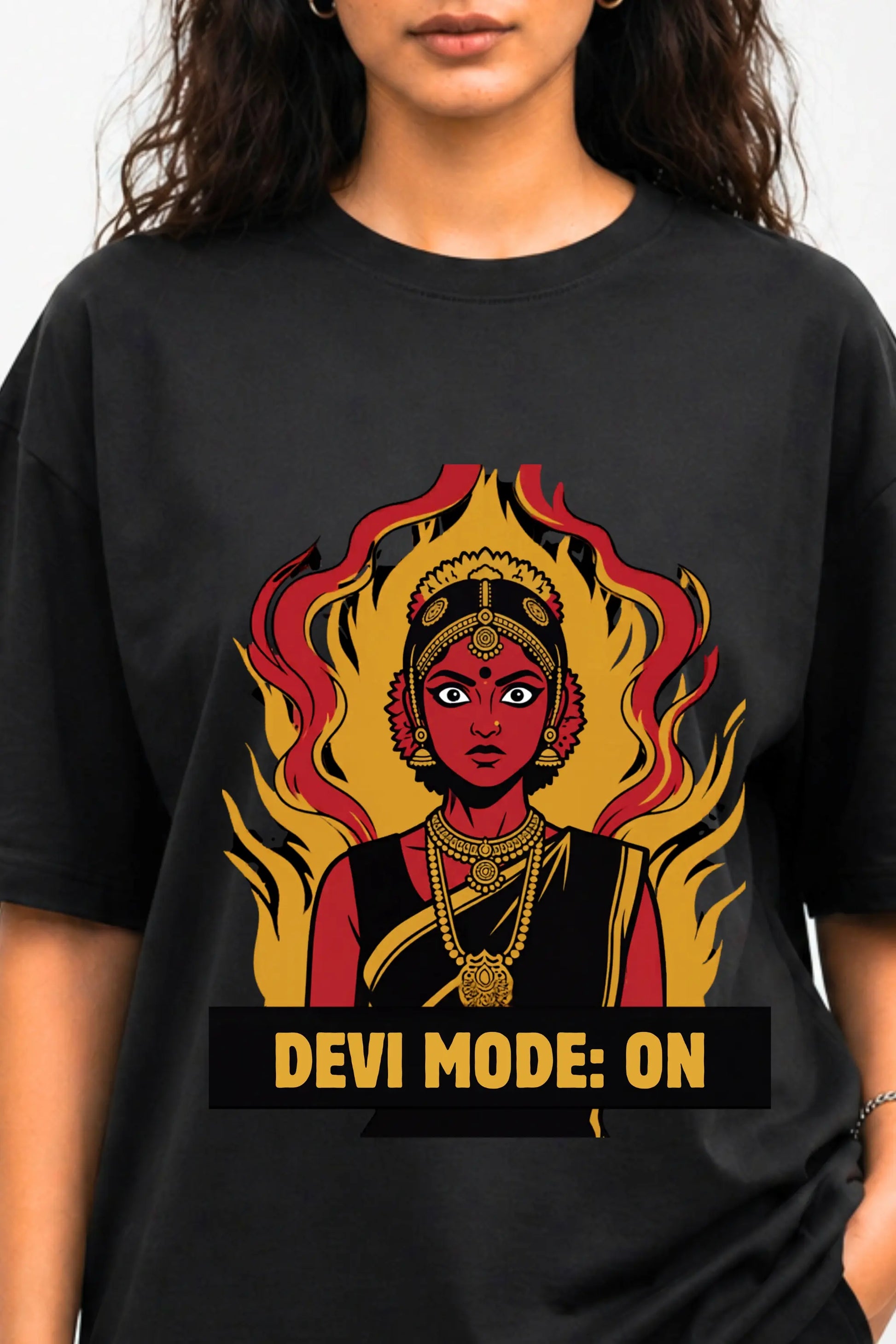 Close-up of Devi Mode On graphic — bold Desi manga Devi illustration with flame detail and gold type on black oversized tee | JUNOSHI