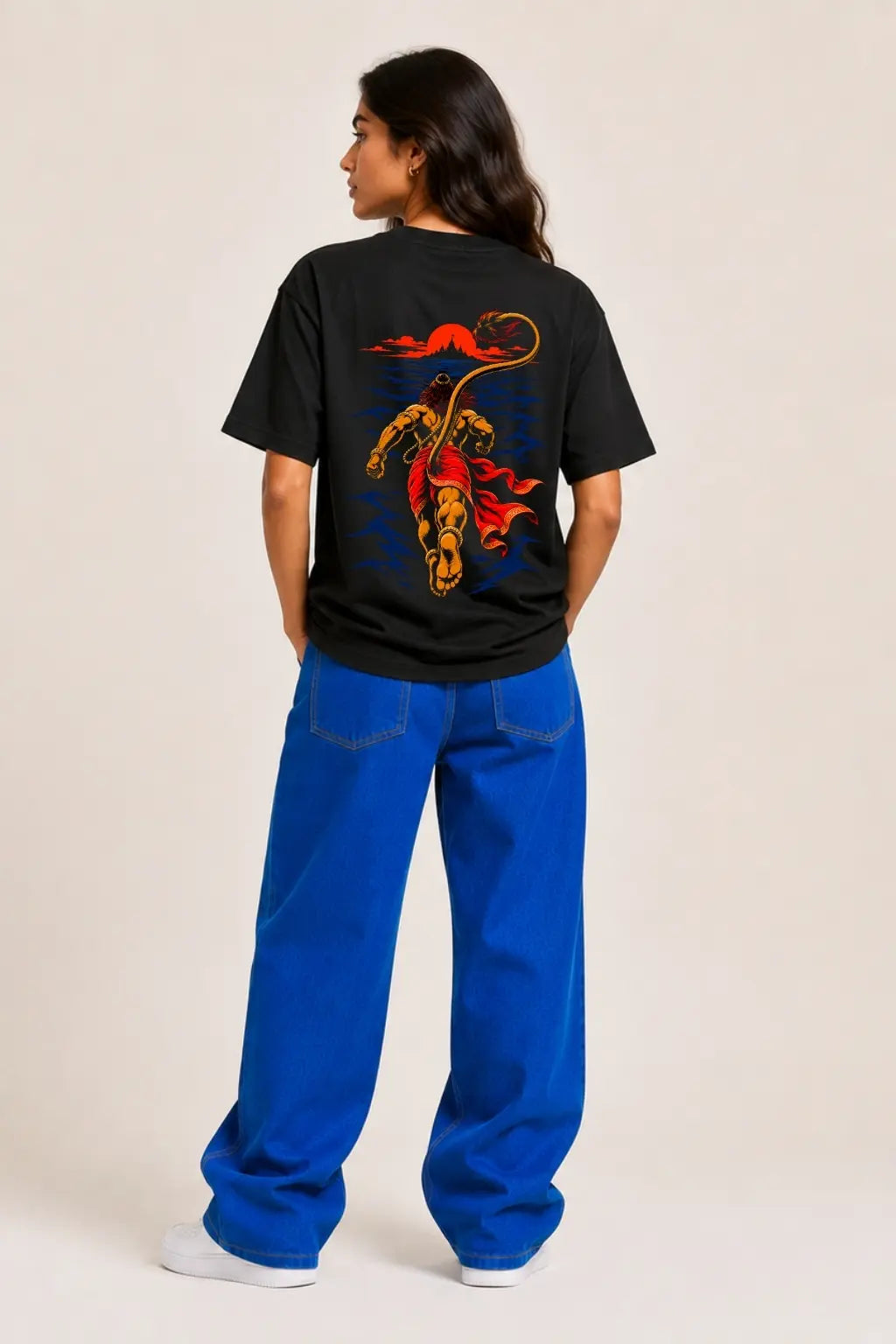 Hanuman Samudra Langhan oversized t-shirt back print worn by female model with blue jeans — Divine Street devotional streetwear