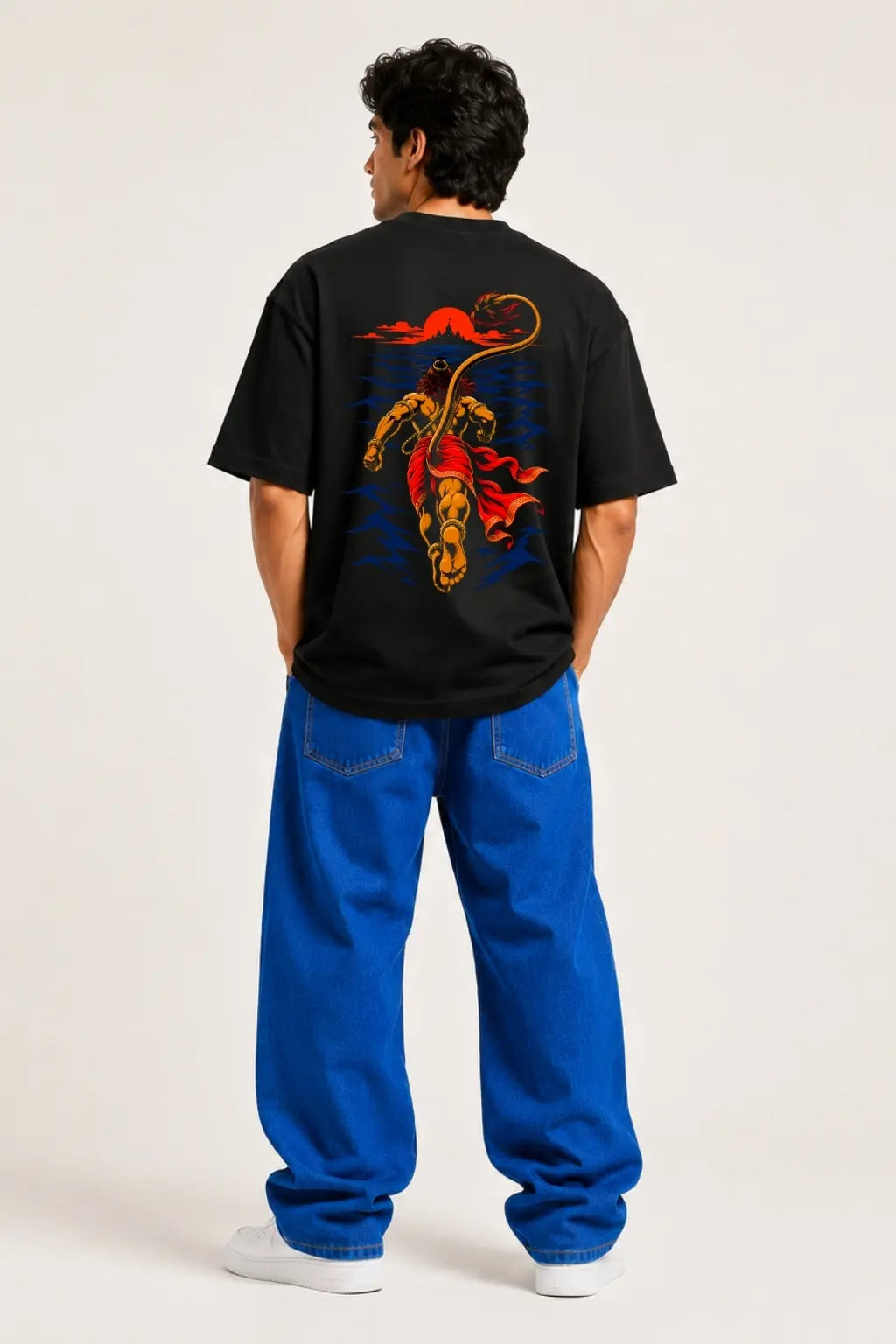 Hanuman Samudra Langhan oversized t-shirt back print worn by male model with blue jeans — Divine Street devotional streetwear