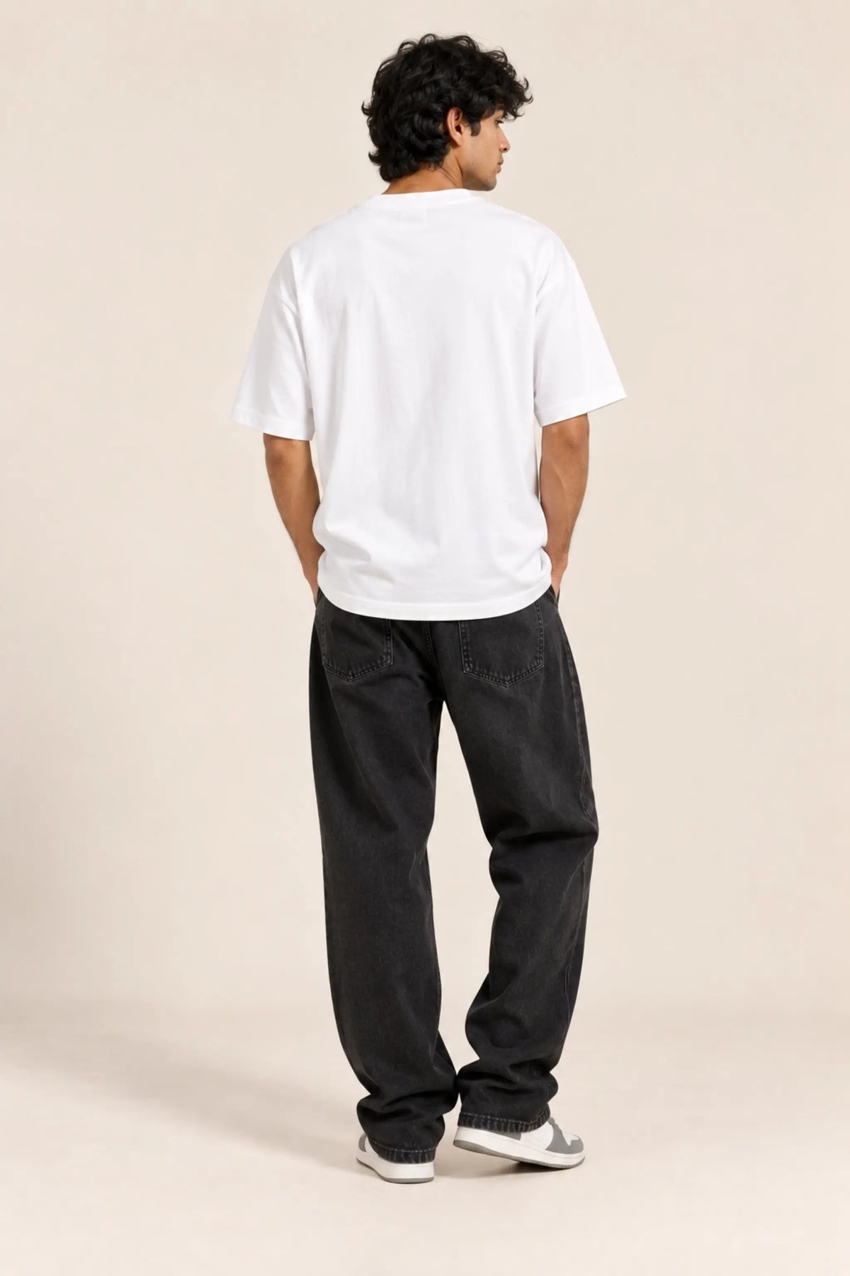 Plain back view of Har Kisi Ko Samajh Nahi Aaoonga white oversized t-shirt on male model | JUNOSHI