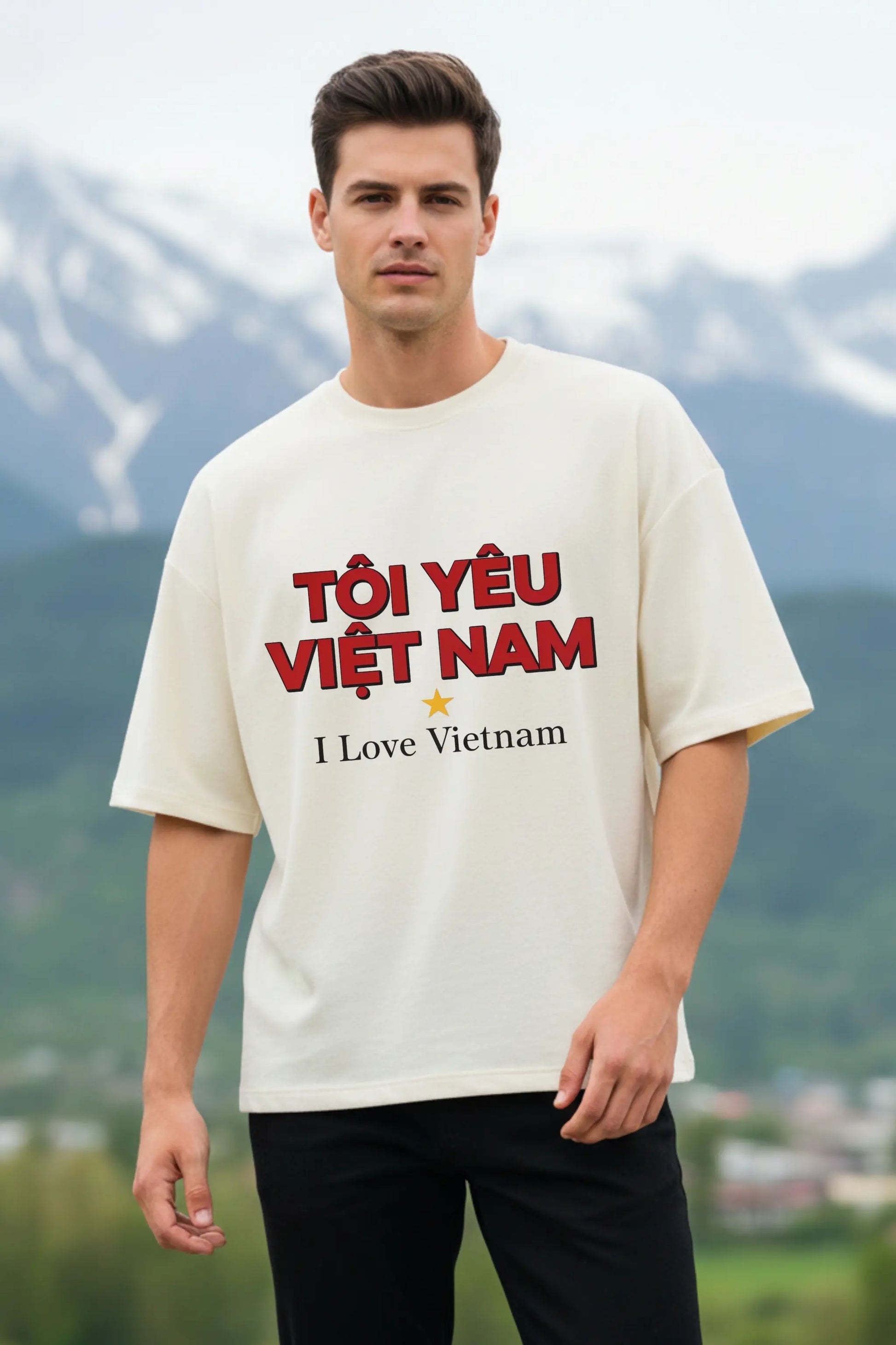 Off-white I Love Vietnam oversized terry t-shirt — unisex travel graphic tee with Vietnamese text, worn against a mountain landscape | JUNOSHI