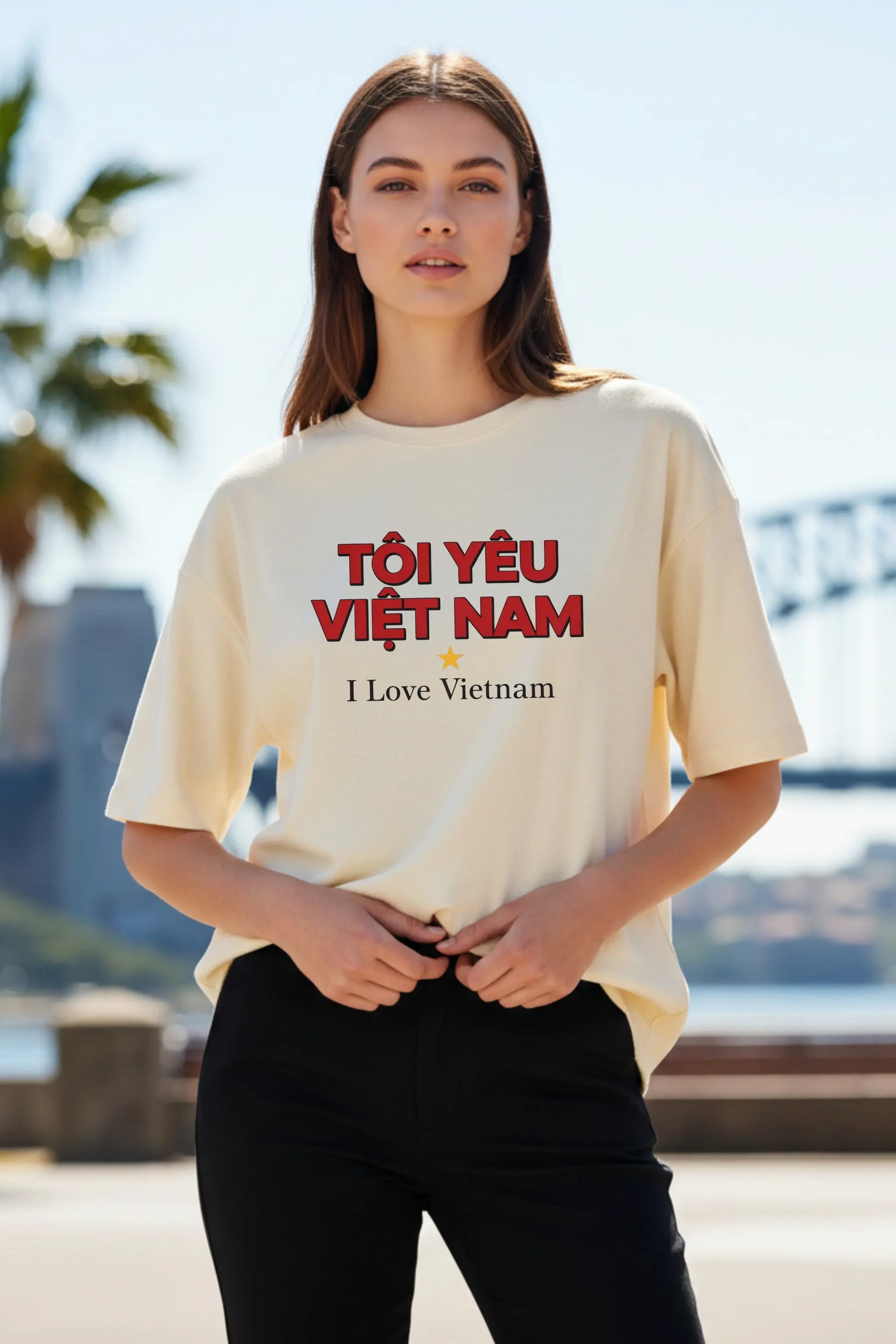 Woman wearing I Love Vietnam off-white oversized t-shirt outdoors — unisex travel graphic tee | JUNOSHI