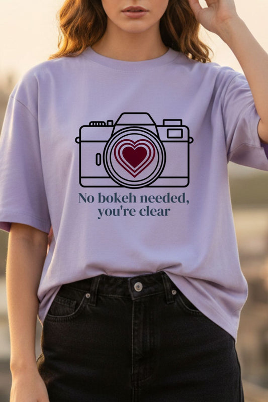 Close-up of Love Focus Photographer Tee — vintage camera heart lens DTF print on lavender oversized tshirt | JUNOSHI
