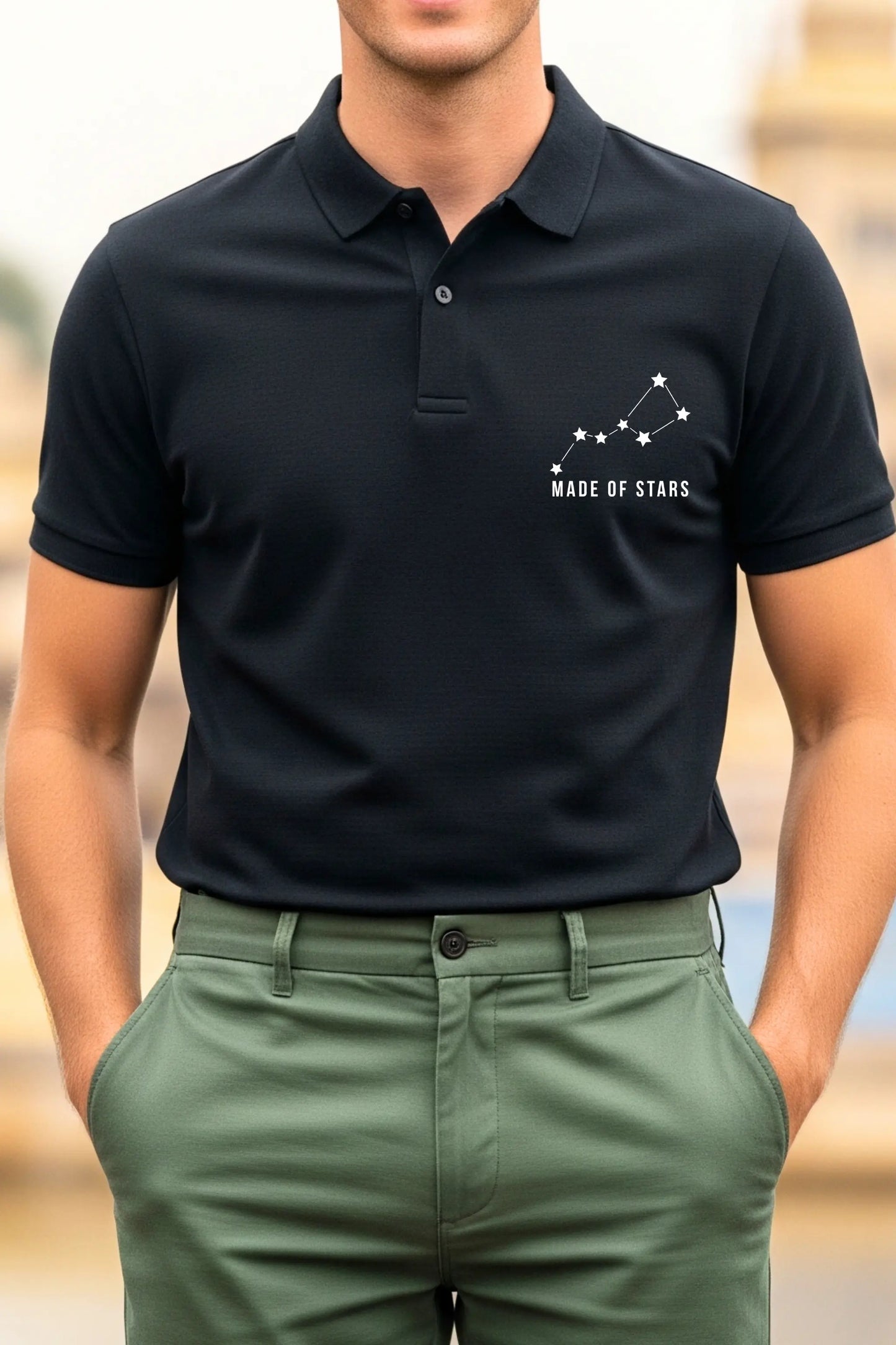JUNOSHI Made of Stars black polo — close-up of white constellation graphic and Made of Stars text on left chest of men's polo