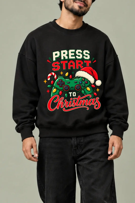 Press Start To Christmas — Santa hat gamepad and fairy lights DTF print close-up on black oversized sweatshirt | JUNOSHI