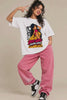 Reel of a smiling woman in the Desi Girl Anime Soul off-white oversized terry t-shirt with pink baggy jeans and sneakers, desi anime streetwear by JUNOSHI