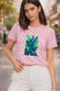 Young Indian woman wearing a baby pink graphic t-shirt featuring two royal blue peacocks framed by neon green banana leaves, styled with white trousers on an urban street — Neon Peacock & Banana Leaves T-Shirt by JUNOSHI