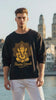 Video of a young male wearing a black oversized sweatshirt with a "golden ganesha diwali" design