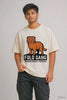 Man wearing cream oversized terry tee with Scottish Fold cat graphic and text Fold Gang Seedha Nahin Fold Hai — JUNOSHI Pet Pawtrait drop