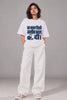 Woman in white unisex oversized terry tee with navy Ambedkar portrait and Woh Kalam Jisne Zameen Badal Di Hindi print, short styling reel | Written in Stone | JUNOSHI