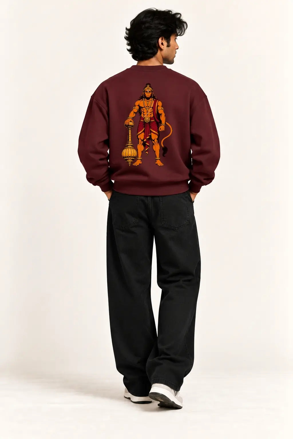 Back view of a maroon oversized sweatshirt with a Lord Hanuman gada illustration in orange and gold, devotional streetwear | JUNOSHI