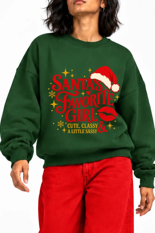 Close-up of Santa’s Favorite Girl Christmas sweatshirt print with Santa hat, red lips and gold snowflakes | JUNOSHI