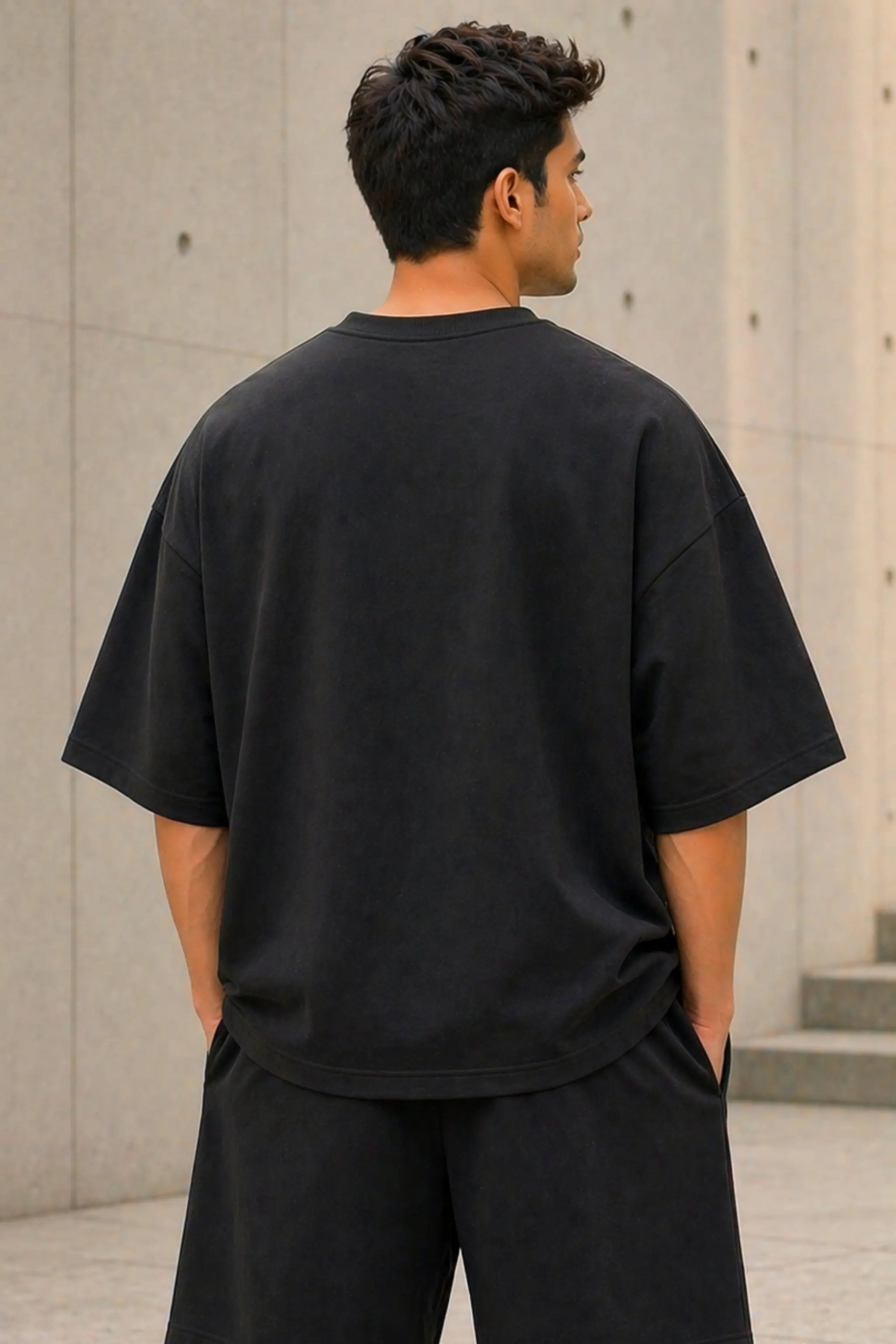 Back view of black premium oversized tee — JUNOSHI Unfinished On Purpose Unfiltered Collection